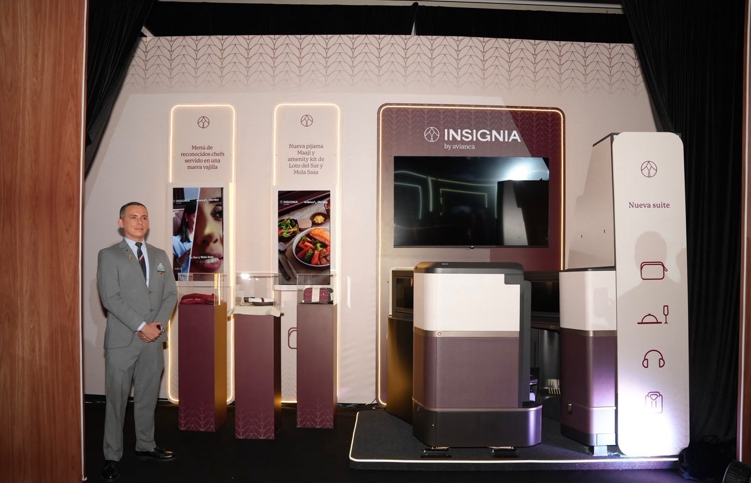 Avianca representative presenting Insignia business class amenity kit display