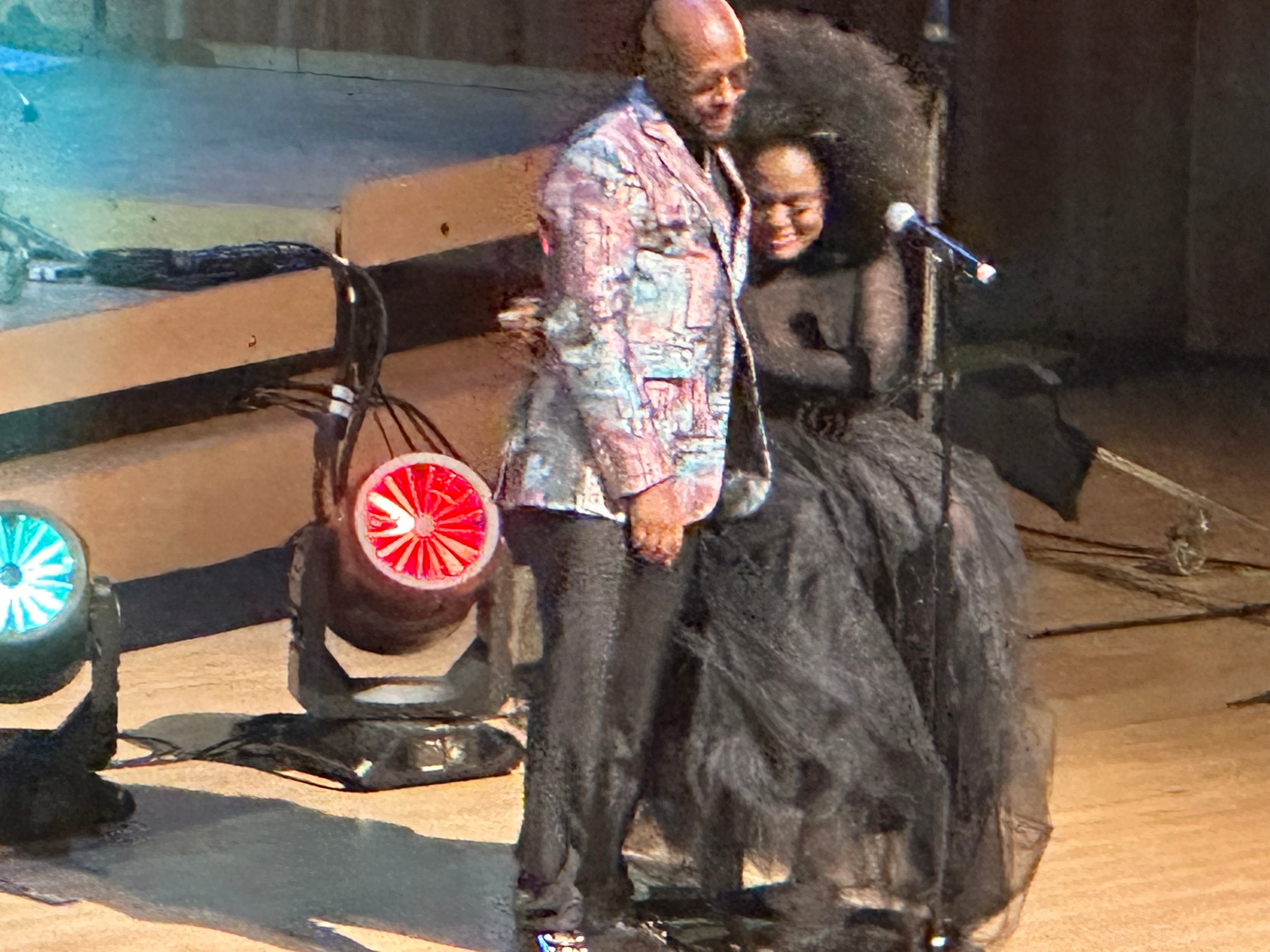 Two performers on stage with microphone at book event
