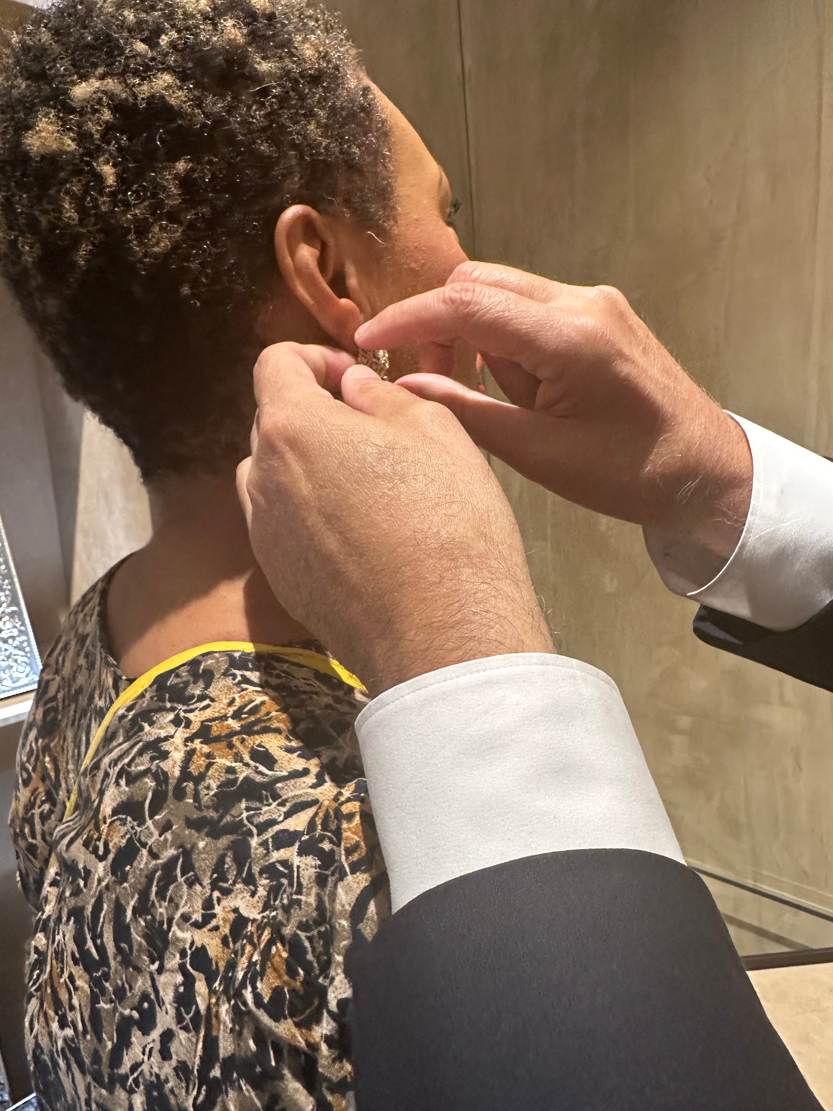Buccellati artisan fitting a gold earring at the Bal Harbour boutique reopening