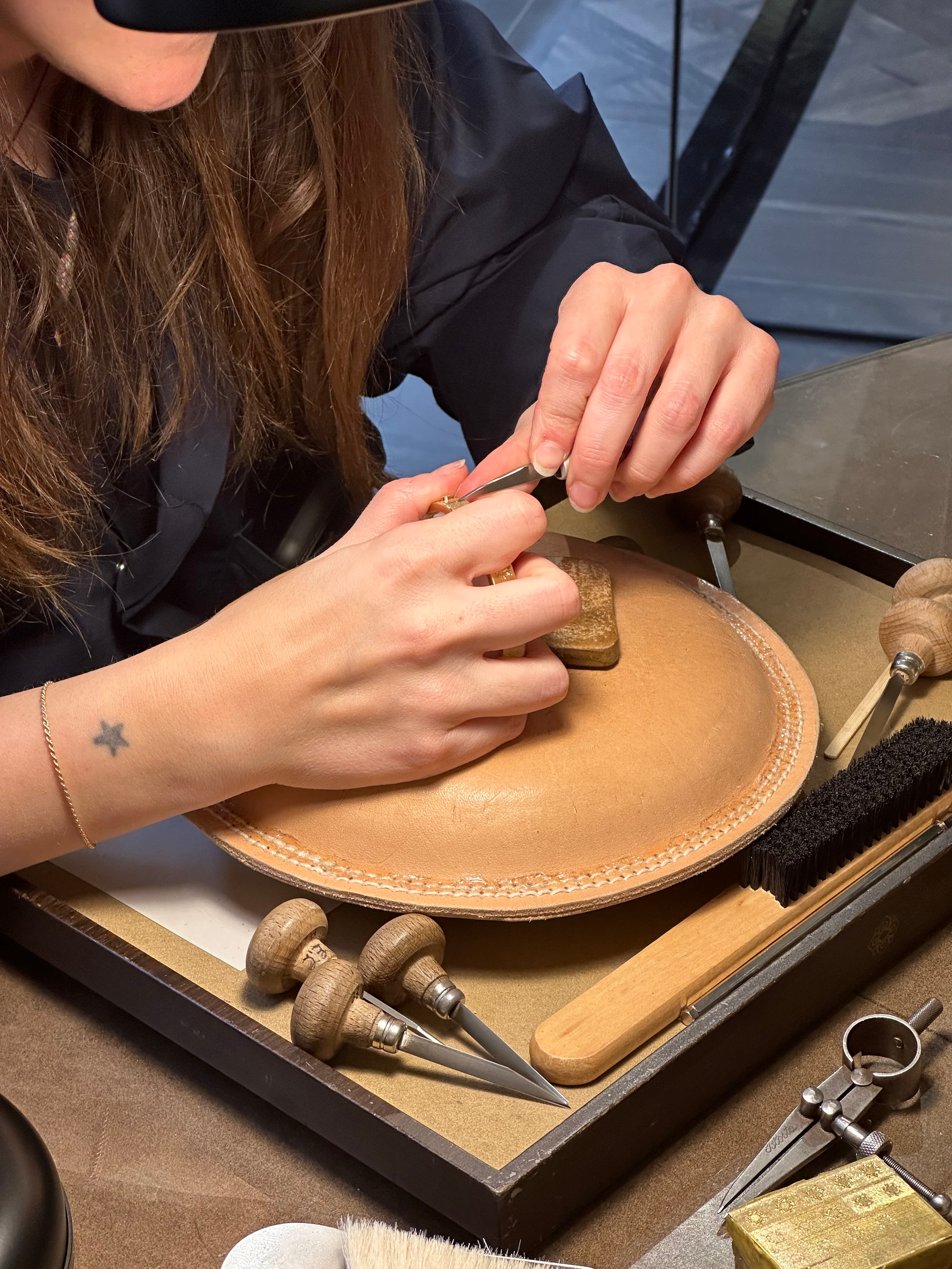 Buccellati artisan demonstrating leatherwork and goldsmithing at the Bal Harbour reopening