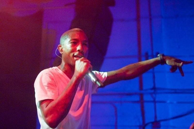 Pharrell pointing into the crowd.